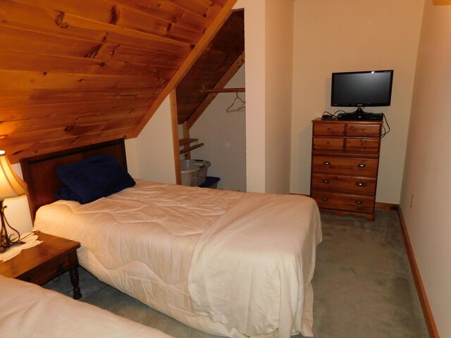61 Sawyer Pond Highlands, Greenville, ME 04441 - carpeted bedroom featuring vaulted ceiling and baseboards