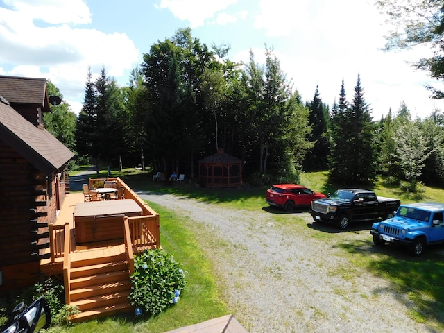 view of yard with a wooden deck and a storage shed