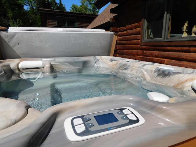 61 Sawyer Pond Highlands, Greenville, ME 04441 - details with log exterior and a jacuzzi