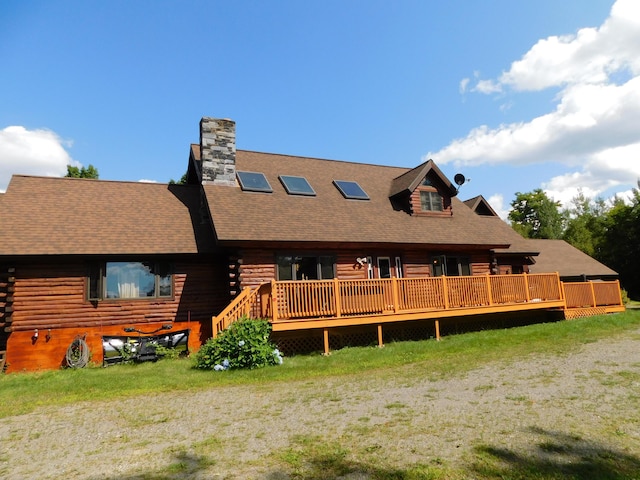 61 Sawyer Pond Highlands, Greenville, ME 04441 - back of property featuring a chimney, a wooden deck, and log siding