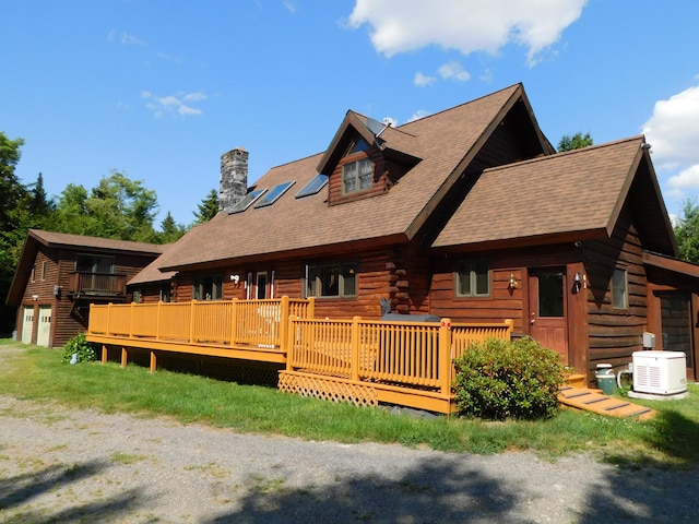 view of front facade featuring cooling unit and a wooden deck