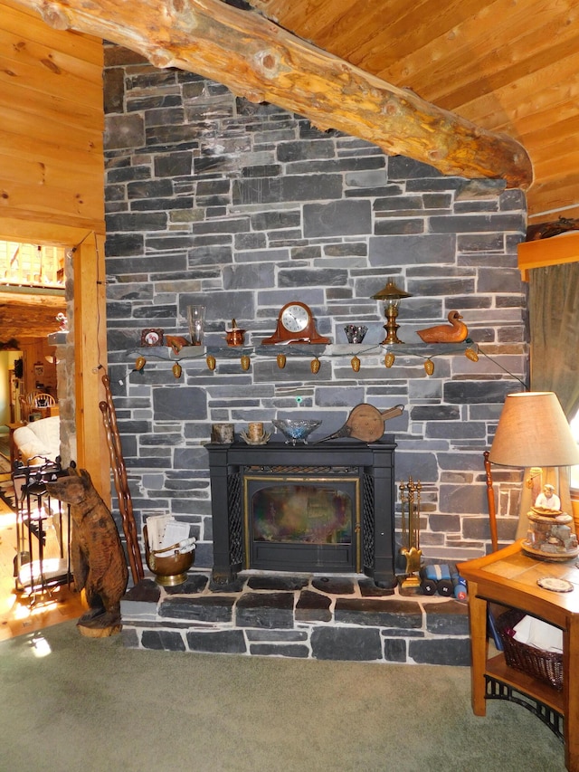 details featuring beam ceiling, a fireplace, and carpet