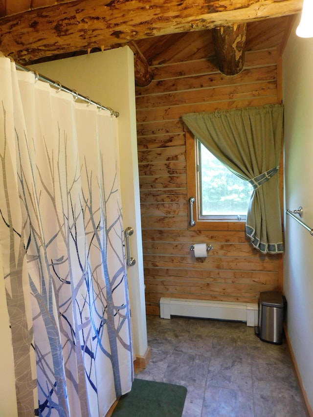 bathroom featuring wooden walls, a baseboard heating unit, and tile patterned flooring