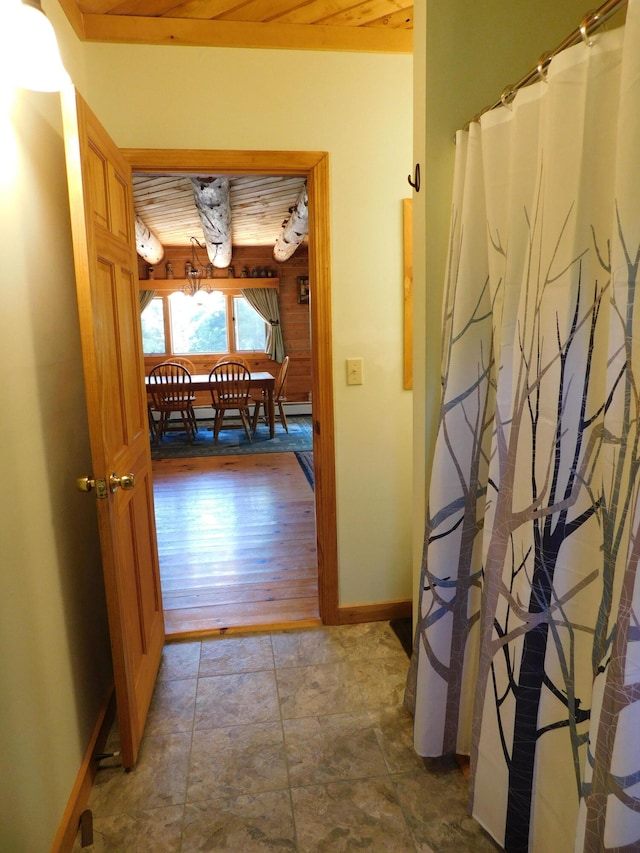 hall featuring wood-type flooring and wood ceiling