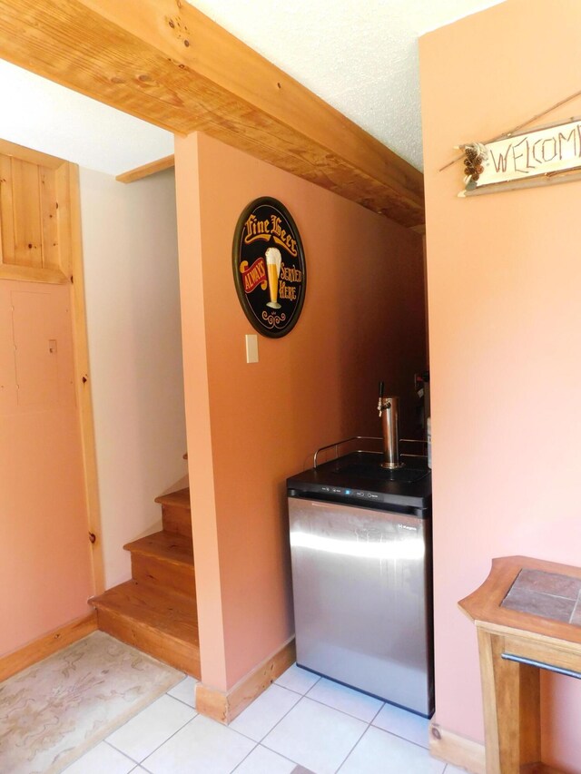 61 Sawyer Pond Highlands, Greenville, ME 04441 - bar with light tile patterned floors, stairway, and baseboards