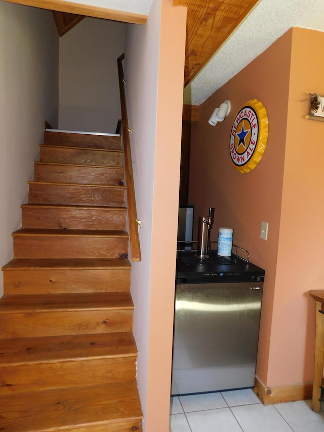 staircase featuring light tile patterned floors