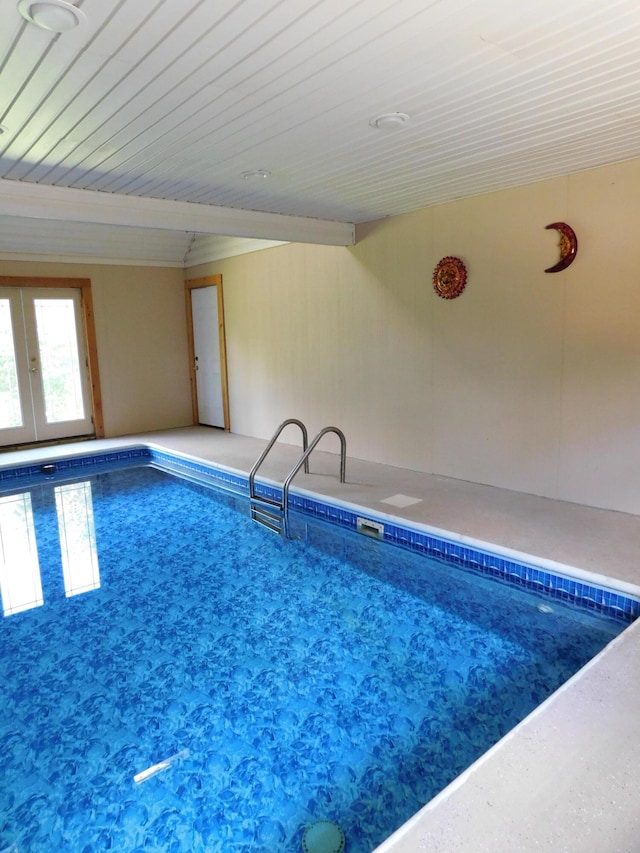 view of swimming pool featuring french doors