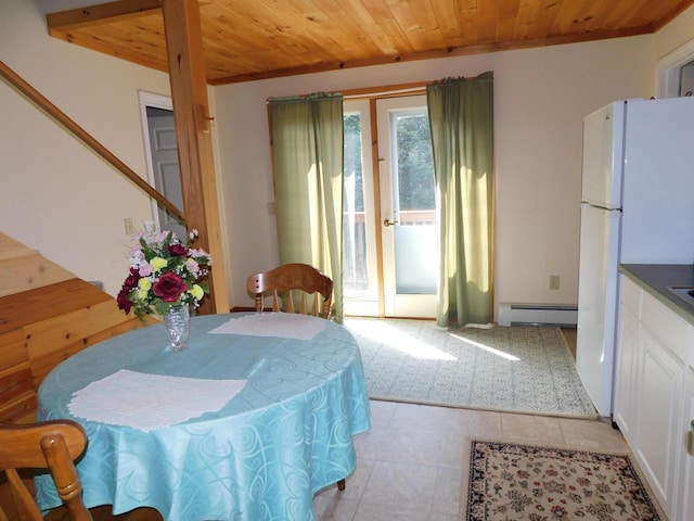 tiled dining space with a baseboard heating unit and wooden ceiling