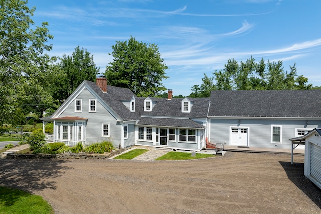 back of house featuring covered porch