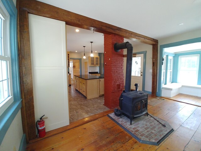 living room with wood-type flooring and a wood stove