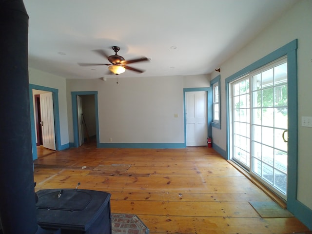 unfurnished living room with ceiling fan and light hardwood / wood-style floors