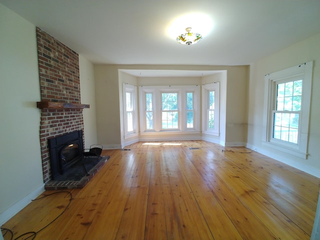 unfurnished living room with hardwood / wood-style floors and a fireplace