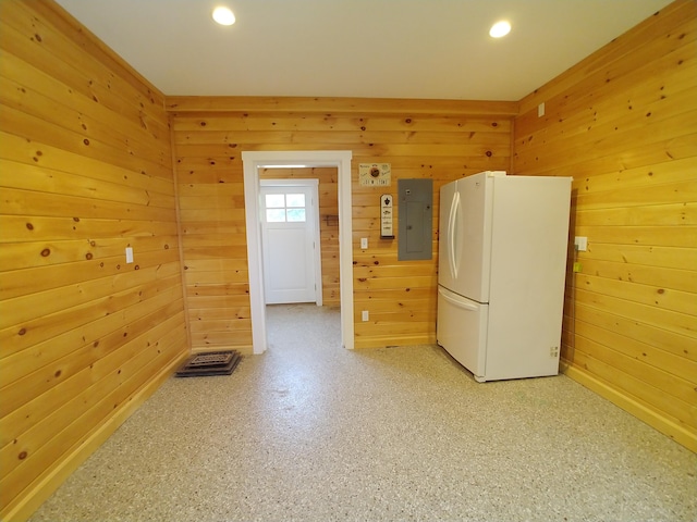 washroom featuring wood walls and electric panel