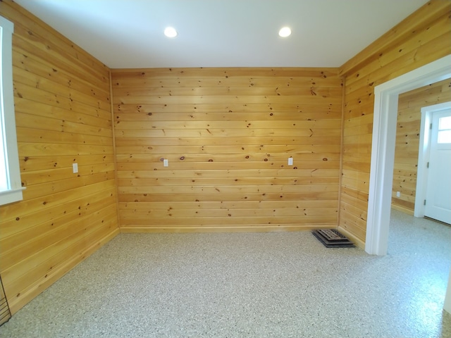 empty room featuring wooden walls