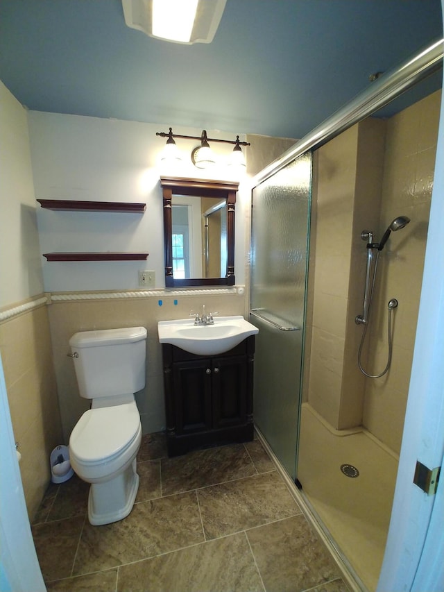 bathroom featuring walk in shower, toilet, and vanity