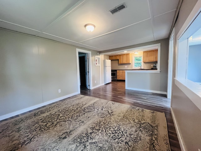 unfurnished living room with dark hardwood / wood-style floors