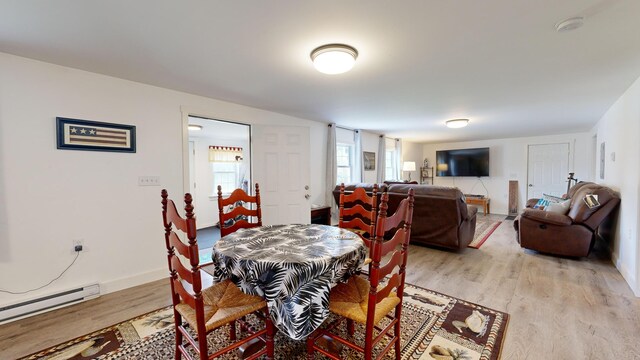 dining area featuring baseboard heating and light hardwood / wood-style flooring