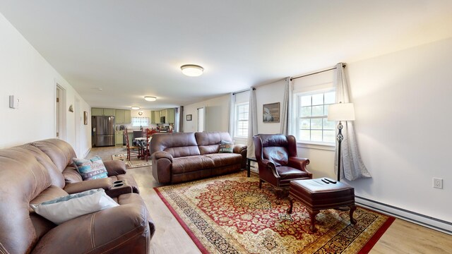 living room featuring baseboard heating and light wood-type flooring