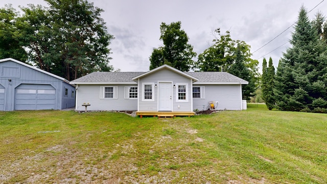 back of property featuring a lawn and a garage