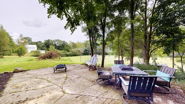 view of patio / terrace with an outdoor fire pit