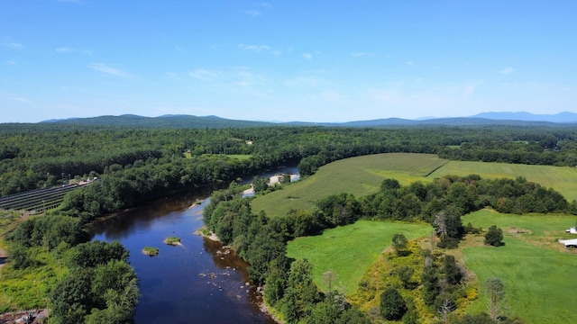 drone / aerial view featuring a water and mountain view