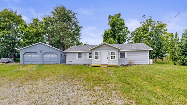 back of property with an outdoor structure, a lawn, and a garage