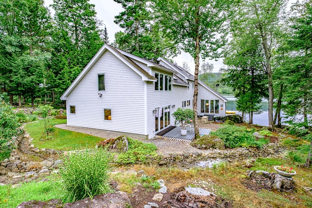 rear view of property featuring a deck