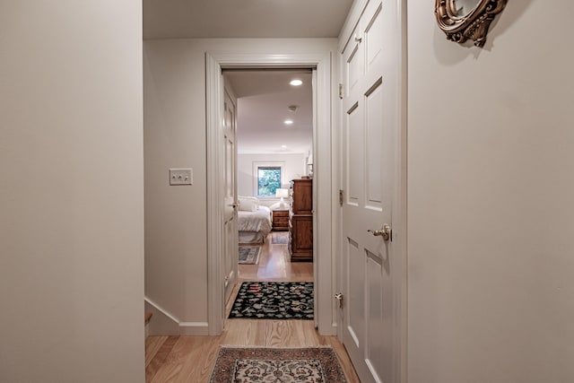 hallway with light hardwood / wood-style flooring