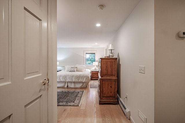 bedroom featuring light hardwood / wood-style floors and baseboard heating