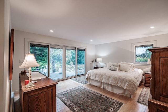 bedroom with access to exterior and light wood-type flooring