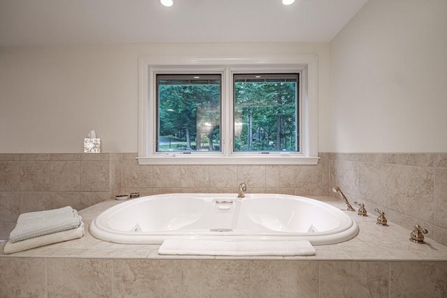 bathroom featuring a relaxing tiled tub