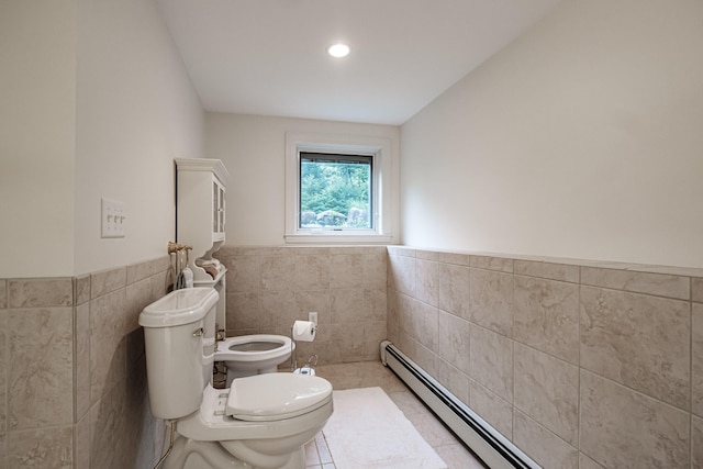 bathroom with a bidet, tile walls, toilet, and tile patterned floors