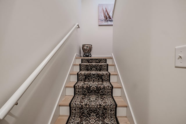 stairway with hardwood / wood-style floors