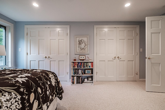 carpeted bedroom with two closets