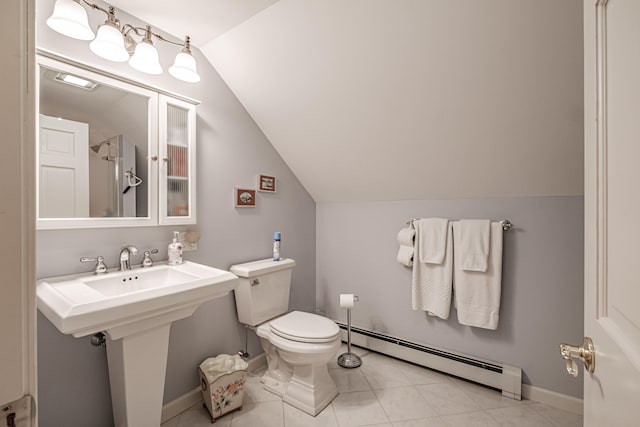 bathroom with tile patterned floors, a baseboard heating unit, lofted ceiling, and toilet