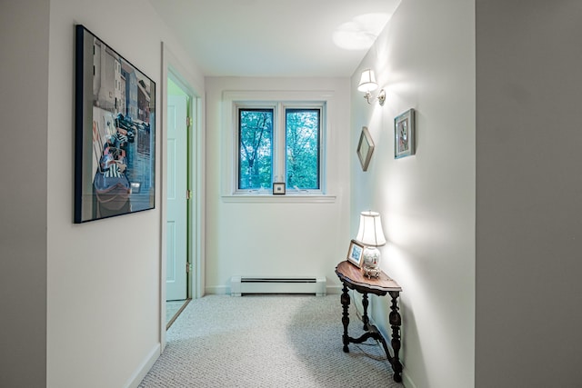 hall featuring a baseboard radiator and carpet