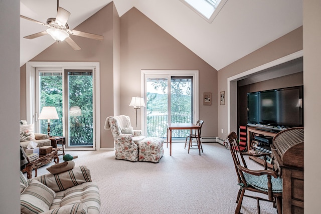 living room with high vaulted ceiling, carpet, ceiling fan, and a skylight