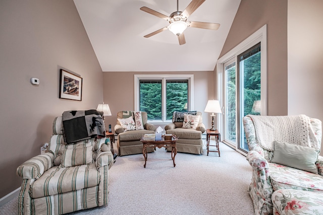 living room featuring vaulted ceiling, light colored carpet, and ceiling fan