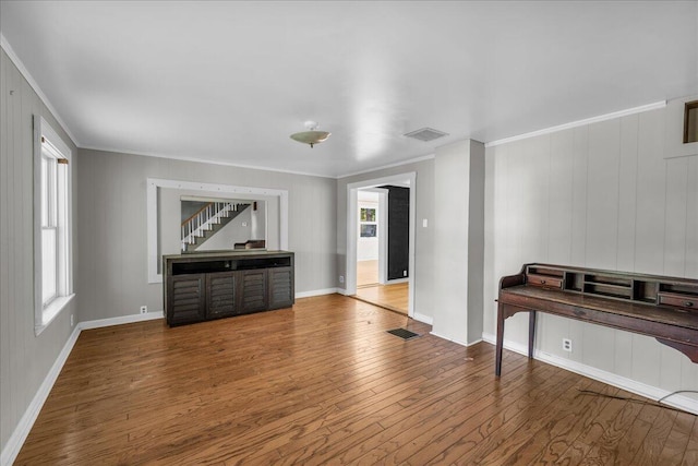 living room with ornamental molding and hardwood / wood-style flooring