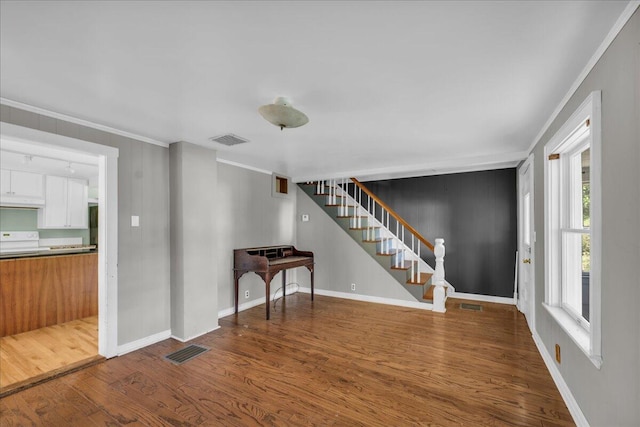 interior space featuring crown molding and hardwood / wood-style flooring