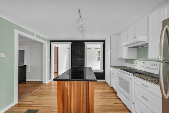 kitchen featuring white cabinets, stainless steel refrigerator, electric range, a center island, and light hardwood / wood-style floors