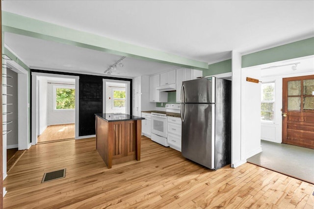 kitchen with white cabinets, white electric range oven, stainless steel fridge, a center island, and light wood-type flooring