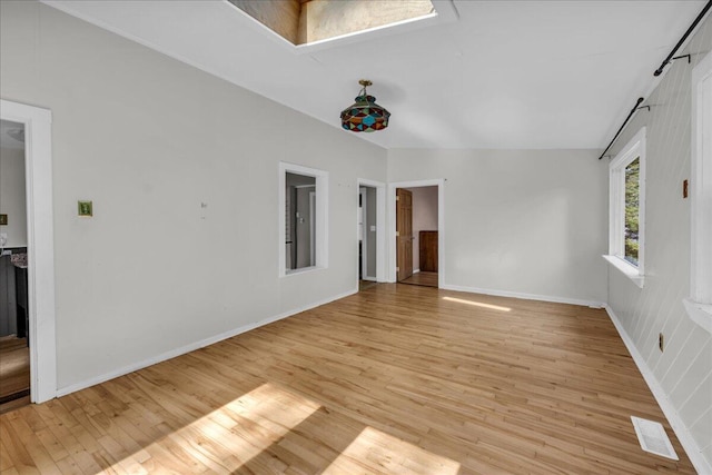 unfurnished room with vaulted ceiling and light hardwood / wood-style floors