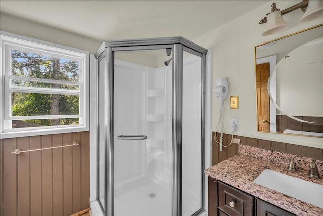 bathroom featuring walk in shower and vanity