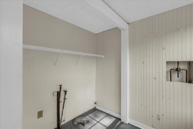 laundry room with washer hookup and wood walls