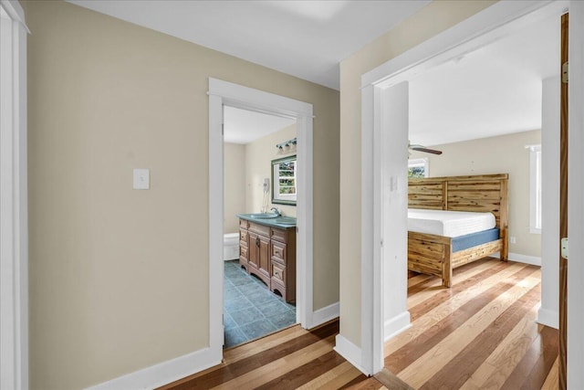 hall featuring hardwood / wood-style floors and sink