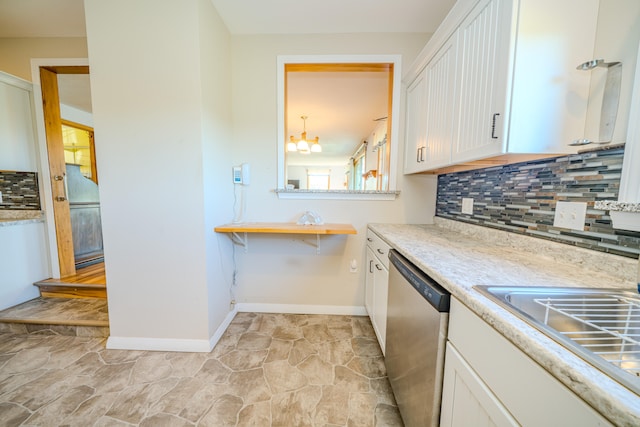 kitchen with a chandelier, dishwasher, backsplash, and white cabinets