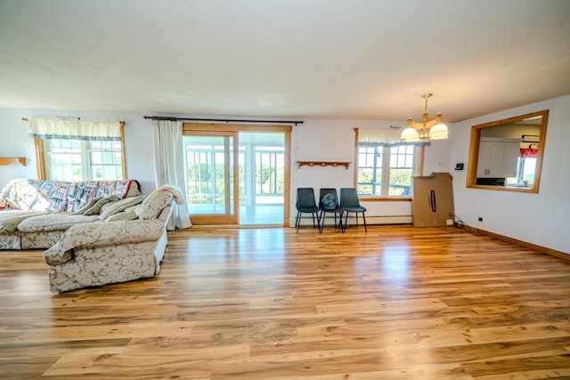 living room featuring light wood-type flooring and a notable chandelier