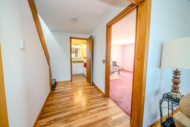 corridor with light wood-type flooring