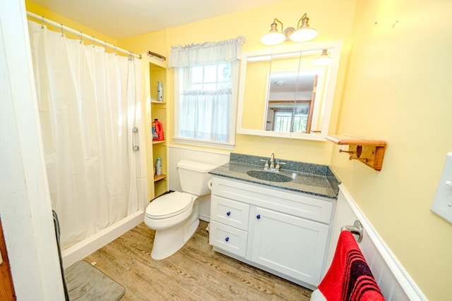 bathroom with vanity, toilet, hardwood / wood-style floors, and a shower with shower curtain